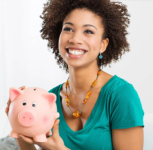 Happy Young Woman Saves Money in Piggy bank